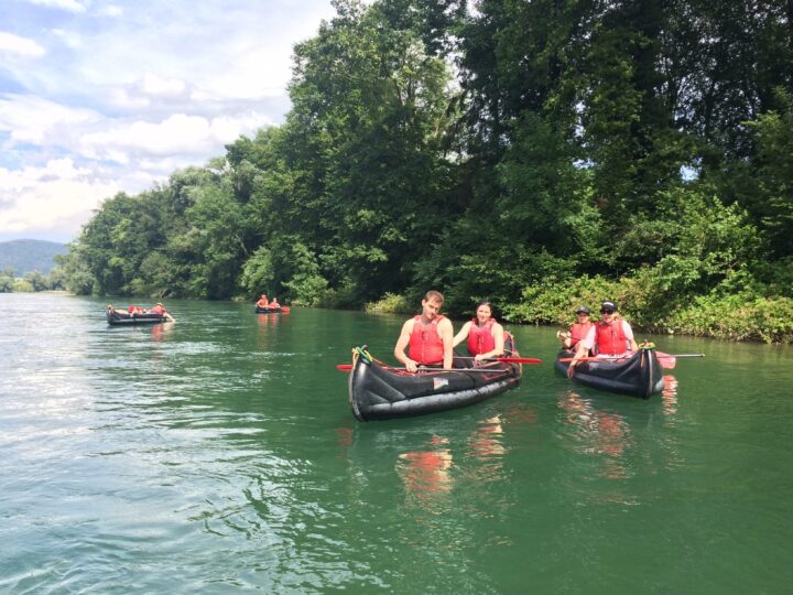 4 Personen lassen sich in Kanus den Rhein heruntertreiben